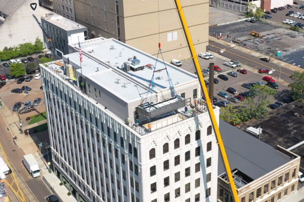 Stainless steel pool craned into place on rooftop