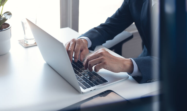 Business man working on laptop computer at modern office. Busine